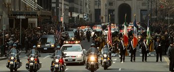 Movie still from “Salt” (2010), directed by Phillip Noyce – A group of people riding motorcycles down a street; Extreme Wide shot, High angle