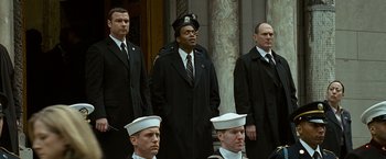 Movie still from “Salt” (2010), directed by Phillip Noyce – A group of men standing next to each other in suits; Medium shot, Low angle