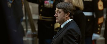 Movie still from “Salt” (2010), directed by Phillip Noyce – A person wearing a suit and tie; Close Up shot, Over the shoulder angle