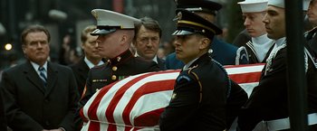 Movie still from “Salt” (2010), directed by Phillip Noyce – Two men in military uniforms carry a flag draped casket; Close Up shot, Over the shoulder angle