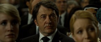 Movie still from “Salt” (2010), directed by Phillip Noyce – A person wearing a suit and tie; Close Up shot, Over the shoulder angle