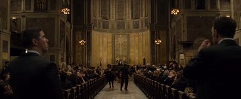 Movie still from “Salt” (2010), directed by Phillip Noyce – A group of people standing in front of an audience in a church; Extreme Wide shot, High angle