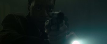 Movie still from “Salt” (2010), directed by Phillip Noyce – A man is holding a gun in his hand; Extreme Close Up shot, Low angle