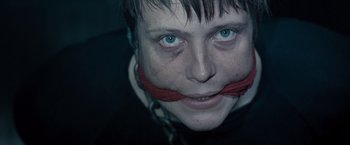 Movie still from “Salt” (2010), directed by Phillip Noyce – A man with a red ribbon around his mouth; Close Up shot, Over the shoulder angle