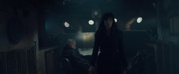 Movie still from “Salt” (2010), directed by Phillip Noyce – A man and a woman standing in a dark room; Medium shot, Low angle