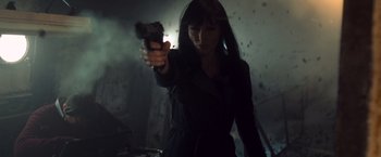 Movie still from “Salt” (2010), directed by Phillip Noyce – A woman holding a gun in a dark room; Close Up shot, Low angle