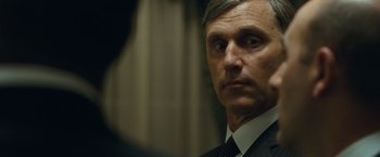 Movie still from “Salt” (2010), directed by Phillip Noyce – A person wearing a suit and tie; Close Up shot, Over the shoulder angle