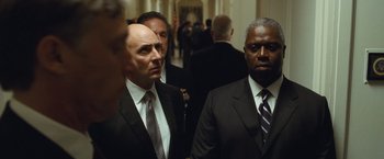 Movie still from “Salt” (2010), directed by Phillip Noyce – A group of men standing next to each other in a hallway; Medium shot, Low angle