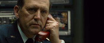 Movie still from “Salt” (2010), directed by Phillip Noyce – A man holding a phone to his ear; Close Up shot, Low angle
