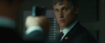 Movie still from “Salt” (2010), directed by Phillip Noyce – A person wearing a suit and tie; Close Up shot, Over the shoulder angle