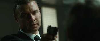 Movie still from “Salt” (2010), directed by Phillip Noyce – A person holding a gun; Close Up shot, Over the shoulder angle