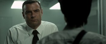 Movie still from “Salt” (2010), directed by Phillip Noyce – A man wearing a white dress shirt and a black tie; Close Up shot, Over the shoulder angle