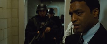 Movie still from “Salt” (2010), directed by Phillip Noyce – A group of men in black suits and helmets; Close Up shot, Over the shoulder angle