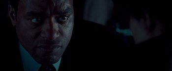 Movie still from “Salt” (2010), directed by Phillip Noyce – A person wearing a suit and tie; Close Up shot, Over the shoulder angle