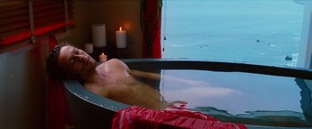 Movie still from “Savages” (2012), directed by Oliver Stone – A man sitting in a bath tub in front of a window; Medium shot, High angle