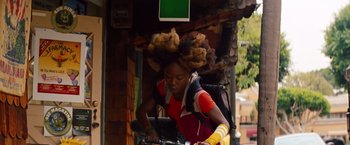 Movie still from “Savages” (2012), directed by Oliver Stone – A woman riding a bike down a street; Medium shot, Low angle