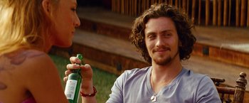 Movie still from “Savages” (2012), directed by Oliver Stone – A man holding a bottle of beer while talking to a woman; Close Up shot, Over the shoulder angle