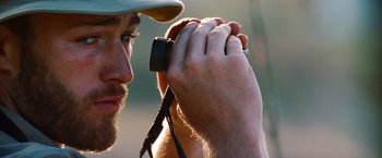 Movie still from “Savages” (2012), directed by Oliver Stone – A person holding a cell phone; Close Up shot, Over the shoulder angle