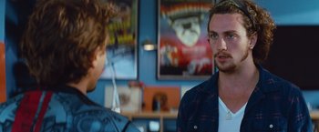 Movie still from “Savages” (2012), directed by Oliver Stone – A man standing next to another man in a room; Close Up shot, Over the shoulder angle