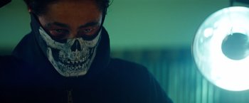 Movie still from “Savages” (2012), directed by Oliver Stone – A man with a skull mask on his face; Close Up shot, Low angle