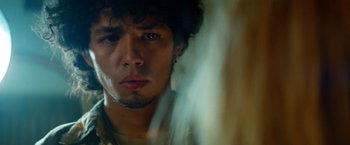 Movie still from “Savages” (2012), directed by Oliver Stone – A man with a beard and a necklace is looking at the camera; Close Up shot, Low angle