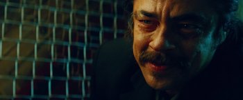 Movie still from “Savages” (2012), directed by Oliver Stone – A person wearing a suit and tie; Close Up shot, Over the shoulder angle