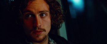 Movie still from “Savages” (2012), directed by Oliver Stone – A person with curly hair; Close Up shot, Low angle