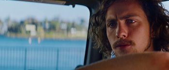 Movie still from “Savages” (2012), directed by Oliver Stone – A person in a car looking out the window; Close Up shot, Over the shoulder angle