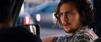 Movie still from “Savages” (2012), directed by Oliver Stone – A person sitting in a car; Close Up shot, Over the shoulder angle