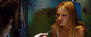 Movie still from “Savages” (2012), directed by Oliver Stone – A woman holding a spoon in front of her face; Close Up shot, Low angle