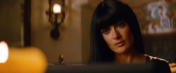 Movie still from “Savages” (2012), directed by Oliver Stone – A person with long black hair; Close Up shot, Over the shoulder angle