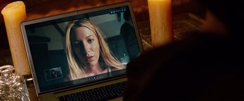 Movie still from “Savages” (2012), directed by Oliver Stone – A laptop computer sitting on top of a wooden desk; Close Up shot, High angle