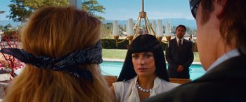 Movie still from “Savages” (2012), directed by Oliver Stone – A woman in a white shirt is talking to another woman; Close Up shot, Over the shoulder angle