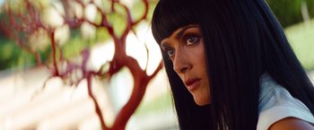 Movie still from “Savages” (2012), directed by Oliver Stone – A person with long black hair; Close Up shot, Low angle