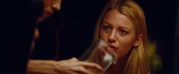 Movie still from “Savages” (2012), directed by Oliver Stone – A person holding a glass of water; Close Up shot, Over the shoulder angle