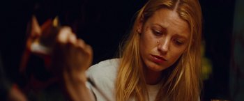 Movie still from “Savages” (2012), directed by Oliver Stone – A woman sitting in front of a mirror looking down; Close Up shot, High angle