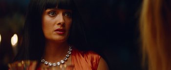 Movie still from “Savages” (2012), directed by Oliver Stone – A person wearing a dress and a necklace; Close Up shot, Over the shoulder angle