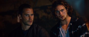 Movie still from “Savages” (2012), directed by Oliver Stone – Two men sitting next to each other in a dark room; Close Up shot, Low angle