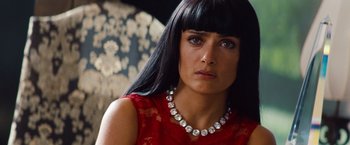 Movie still from “Savages” (2012), directed by Oliver Stone – A person wearing a necklace; Close Up shot, Over the shoulder angle