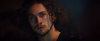 Movie still from “Savages” (2012), directed by Oliver Stone – A person with long curly hair; Close Up shot, Low angle