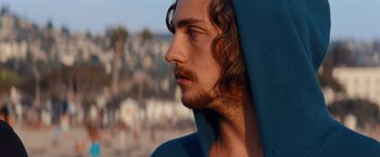 Movie still from “Savages” (2012), directed by Oliver Stone – A person with long curly hair; Close Up shot, Low angle