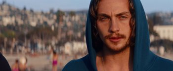 Movie still from “Savages” (2012), directed by Oliver Stone – A person wearing a hooded sweatshirt; Close Up shot, Over the shoulder angle