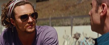 Movie still from “Savages” (2012), directed by Oliver Stone – A person wearing sunglasses; Close Up shot, Over the shoulder angle