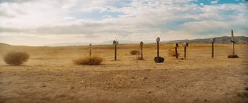 Movie still from “Savages” (2012), directed by Oliver Stone – A number of different mail boxes in a field; Extreme Wide shot, High angle