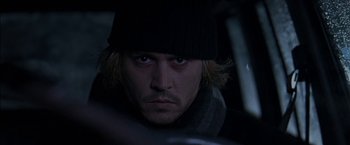 Movie still from “Secret Window” (2004), directed by David Koepp – A man with long blonde hair wearing a black hat; Close Up shot, Over the shoulder angle