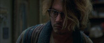 Movie still from “Secret Window” (2004), directed by David Koepp – A person wearing glasses and a sweater; Close Up shot, Over the shoulder angle