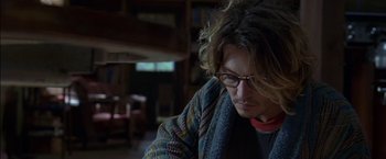 Movie still from “Secret Window” (2004), directed by David Koepp – A person with glasses is sitting in a room; Close Up shot, Low angle