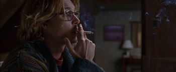 Movie still from “Secret Window” (2004), directed by David Koepp – A man smoking a cigarette while wearing glasses; Close Up shot, Low angle