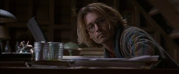 Movie still from “Secret Window” (2004), directed by David Koepp – A man sitting at a table with a glass of water in front of him; Close Up shot, Over the shoulder angle
