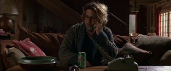 Movie still from “Secret Window” (2004), directed by David Koepp – A man sitting at a table talking on the phone; Medium shot, High angle